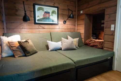 a couch with pillows on it in a room at Budalen, spacious cabin close to skitracks in Holo