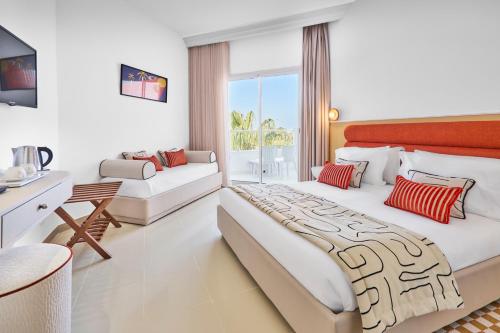 a hotel room with a large bed and a desk at Houda Yasmine Marina & SPA in Hammamet