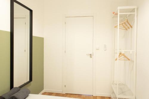 a bedroom with a mirror and a closet at Magdalena2 Street, Private rooms in Madrid