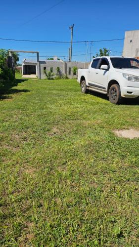 a white truck parked in a field of grass at Azahares Apart in Bella Vista