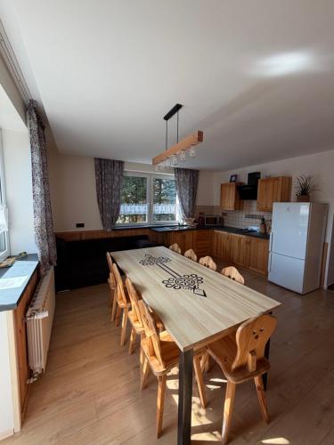 a kitchen with a large wooden table and chairs at Willa Emma in Poronin