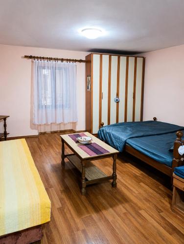 a bedroom with a bed and a table in it at Native Apartments in Budva