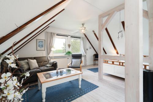 a living room with a couch and a table at Landstuuv in Neustadt in Holstein