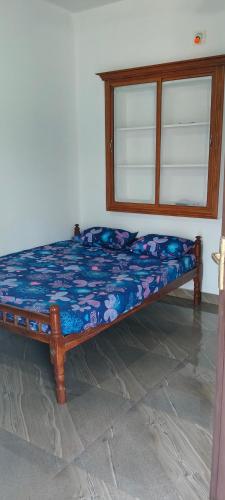a bed sitting in a room with a window at Darshan Stay in Trichūr