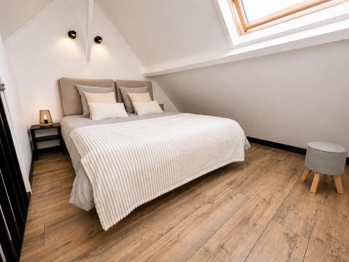 a bedroom with a large bed in a attic at Les Toits d'Arras in Arras