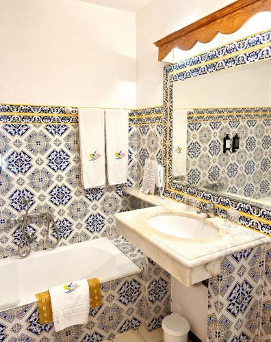 a bathroom with a sink and a toilet and a tub at Hotel Quinta Da Lagoa in Praia de Mira