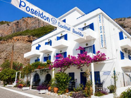a white building with flowers in front of it at Agia Roumeli Hotel adults only Ξενοδοχείο Αγία Ρουμέλη μόνο για ενήλικες in Agia Roumeli