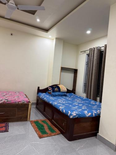 a bedroom with two beds and a mirror at Abc HOTEL & LODGE in Biratnagar