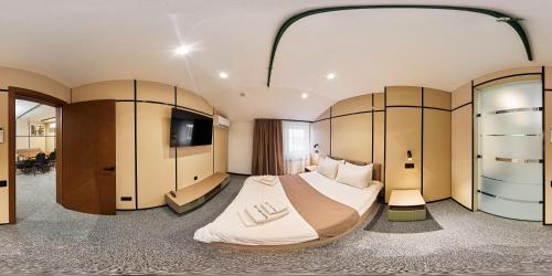 a hotel room with a large bed and a tv at Set Sail Hotel in Oral