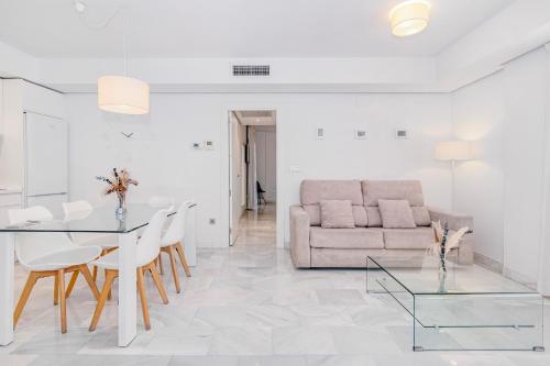 a living room with a couch and a table at Apartamentos Domus con parking gratuito in Granada