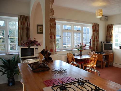 a kitchen and dining room with a table and chairs at The Pottery Annexe in Baslow
