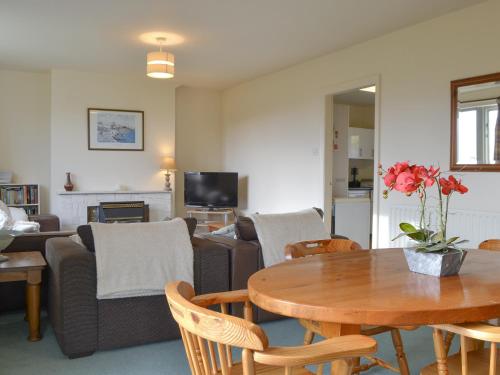 a living room with a table and a couch at Ribblestones in Austwick