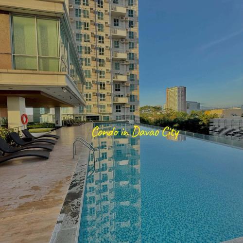 a swimming pool on the side of a building at trendy & Reliable Condo unit in Davao City