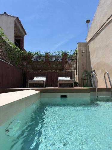 a swimming pool with a water slide in front of a fence at Arena Centro Rooms&Suites in Seville