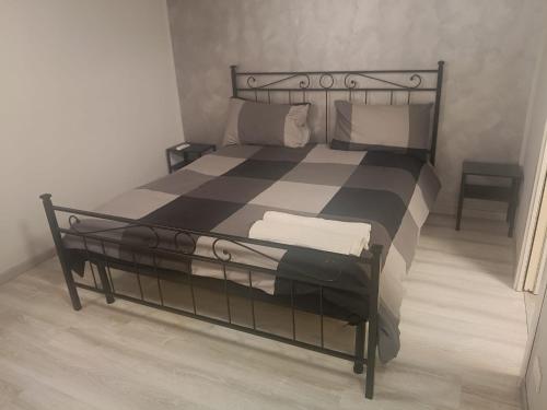 a black and white bed in a room at Living Milano Suite in Cinisello Balsamo