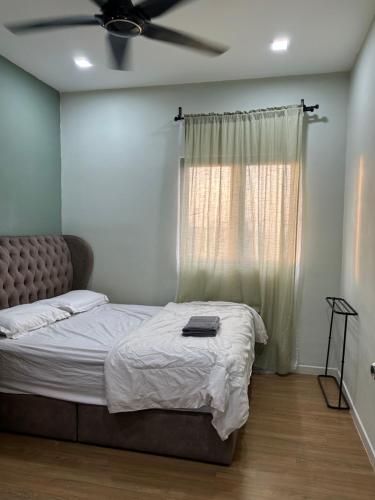 a bedroom with a bed with a ceiling fan at Sunset Retreat Sensory Residence in Kampung Dengkil