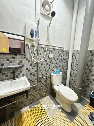 a bathroom with a shower and a toilet and a sink at Cassa Bonda Standard Double Room in Macang