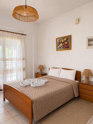 a bedroom with a bed with towels on it at Pilgrimos Apartments in Ierissos