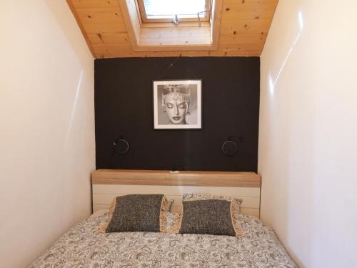 a bedroom with a bed with a black accent wall at "Les Échalas" Charmante maison au coeur du Lavaux, Cully in Cully