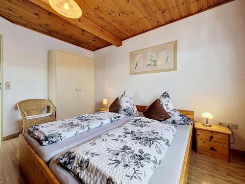 a bedroom with a bed and a wooden ceiling at Apartment Sirch-3 by Interhome in Diedorf