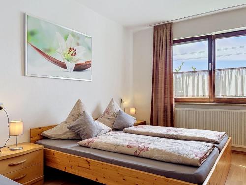 a bedroom with a bed and a large window at Apartment Sirch-4 by Interhome in Diedorf