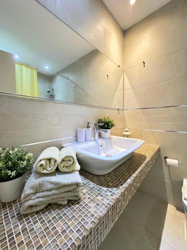 a bathroom with a sink and a bath tub at Apartments Karmen Maria in Novigrad Istria