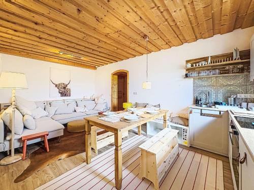 a kitchen and living room with a wooden ceiling at Apartment Apartment 5 by Interhome in Sirnitz