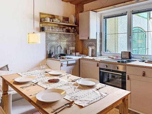 a kitchen with a wooden table with plates on it at Apartment Apartment 5 by Interhome in Sirnitz