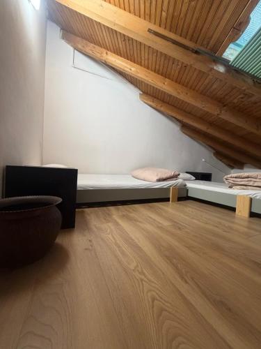 a room with a bed and a wooden floor at Stresa Complex LevOasi in Stresa