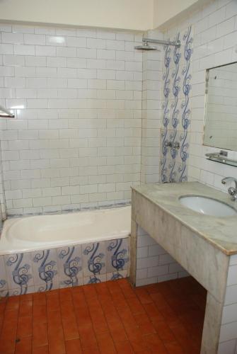 a bathroom with a tub and a sink at Hotel Pleasure Home in Kathmandu