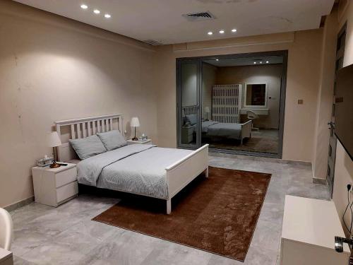 a bedroom with a large bed and a large mirror at Villa with private Pool A in Al Khīrān