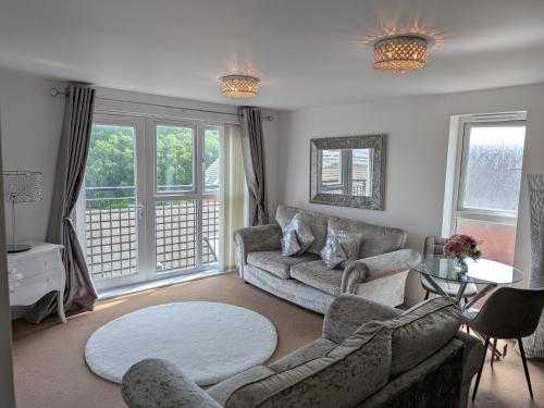 a living room with a couch and a table at Rothwell in Swansea