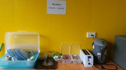a kitchen counter with a plastic container and other kitchen items at Lanta Long Beach Hostel in Ko Lanta