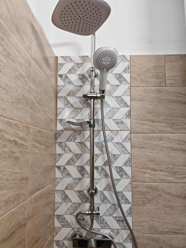 a shower in a bathroom with a shower head at Guest House Plavas in Sozopol