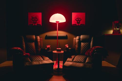 a living room with two chairs and a floor lamp at Le Cocopop in Dinant