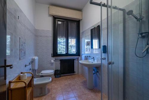 a bathroom with two toilets and a sink and a shower at Locanda San Martino in Collecchio