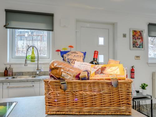 a basket full of groceries sitting on a counter in a kitchen at Craigpark Lodge in Caldercruix