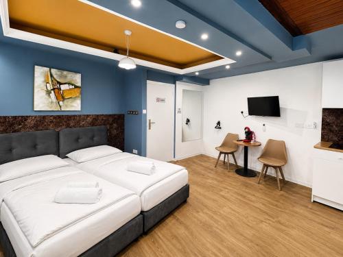 a bedroom with a bed and a tv and a table at Mini Studio N6 private Bathroom and Kitchenette in Limassol