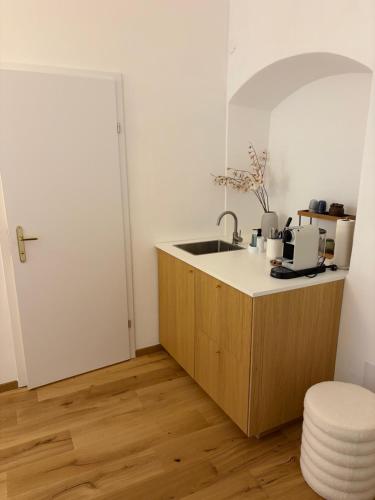 a kitchen with a sink and a counter at room4you Lambach Apartment, Studiozimmer & Zimmer in Lambach