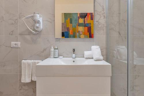 a bathroom with a white sink and a shower at ARMONIA Guest House in Passo Corese