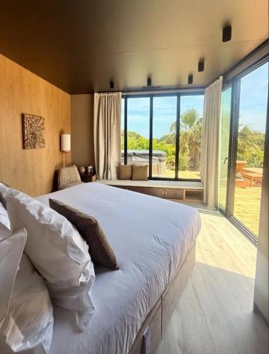 a bedroom with a large bed and a large window at Kon Tiki in Saint-Tropez