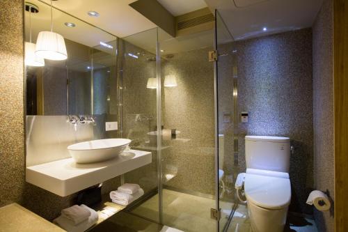 a bathroom with a toilet and a sink and a shower at Inhouse Hotel Taichung in Taichung