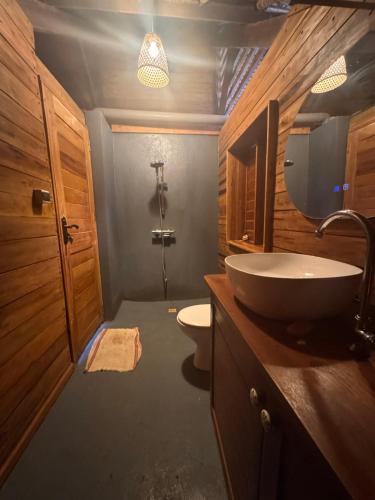 a bathroom with a sink and a toilet at Guest House Antsakoa in Nosy Komba