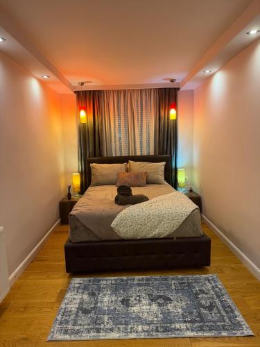 a bedroom with a bed with two lamps and a rug at GZP Residence Lugoj 6 in Lugoj