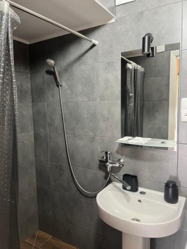 a bathroom with a shower and a sink at Гостинний двір Підкова in Budishche
