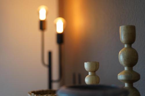 a table with two candles and a candle holder at Happywild in Schlangenbad