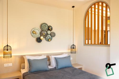 a bedroom with a bed and a clock on the wall at Hotiday Santorini Mesaria in Fira