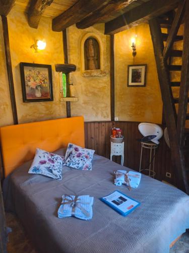 a bedroom with a bed with bows on it at Chambre de la Tour 2 in Milhac