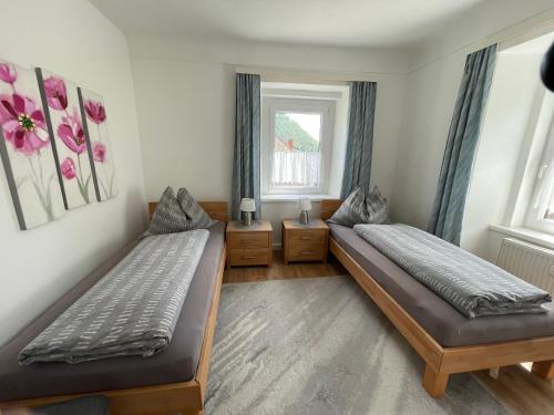 a bedroom with two beds and a window at Vermietung Ronner in Vordernberg