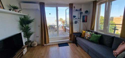 a living room with a couch and a sliding glass door at Bright and Modern Forest Hill Flat - Flexible Stay in Forest Hill